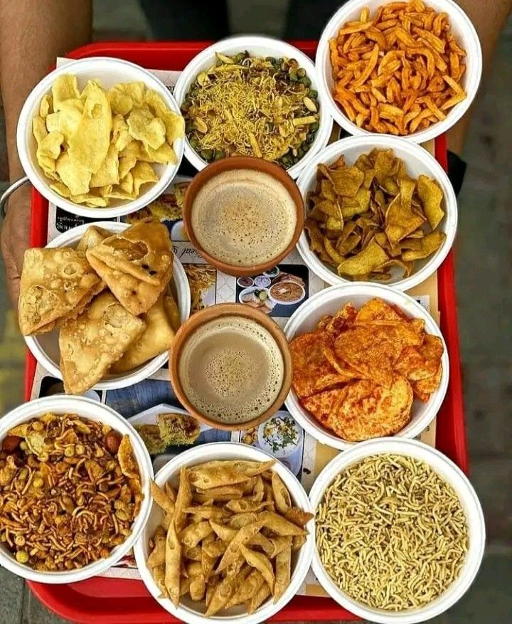 a red tray topped with bowls filled with different types of food next to chips and dips