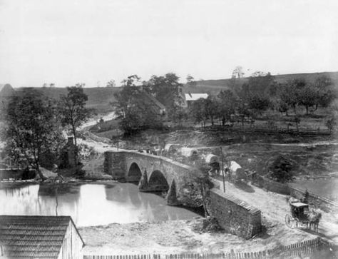 an old black and white photo of a bridge