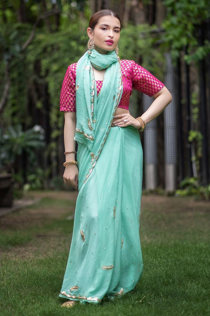 Sea green saree highlighted with dull gold zari embroidery and mini pearls embellishments. Comes with blouse.
Component: 2
Embroidered
Sleeve Type: Half
Fabric: Chiffon
Color: Green
Note: The blouse worn by the model is not for sale - Aza Fashions Sea Green Saree, Green Sari, Zari Embroidery, Saree Poses, Embroidered Saree, Green Saree, Contrast Blouse, Blouse For Women, Fashion App