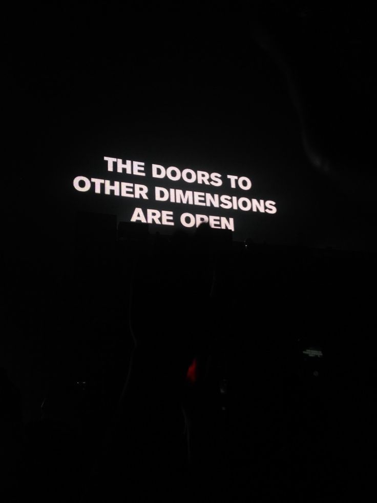 a neon sign that says the doors to other dimensionss are open on a dark background