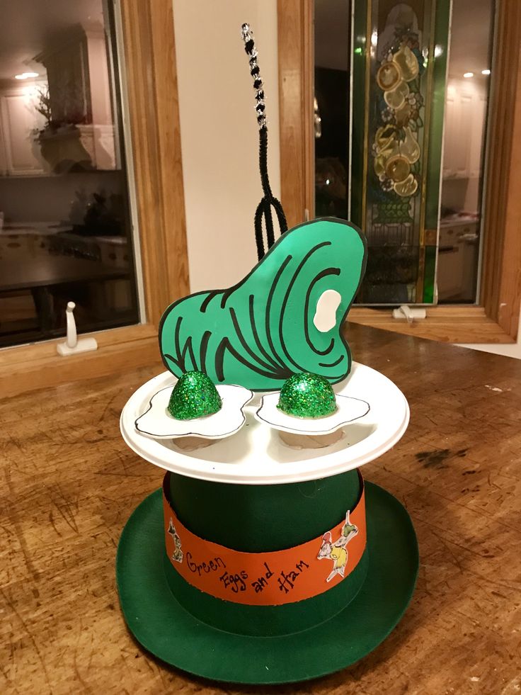 a green and white hat on top of a wooden table