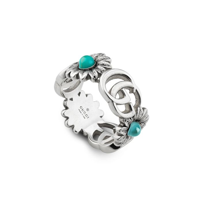 Style ‎527394 J8474 8517An archival reprisal of the House's signature emblem, the Double G motifs appear on a 925 sterling silver ring, separated by flowers with colored stones at the center.925 Sterling silver with aged finishDouble GFlowers with mother of pearl, turquoise-colored resin and blue topaz stonesBand width: .75"Size: 6Made in Italy Gucci Marmont, Gucci Jewelry, Turquoise Ring Silver, Gucci Gg Marmont, Blue Topaz Stone, Luxury Rings, Gg Marmont, Gucci Rings, Multi Stone Ring