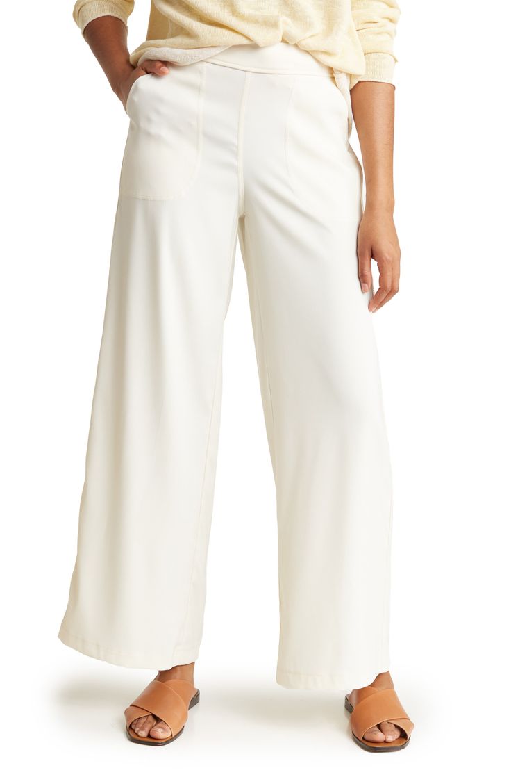 Flowy ankle trousers topped with an elastic waistband are a comfortable workwear essential that will elevate your professional style. 30" inseam, 25" leg opening; 11 1/2" front rise, 16 1/2" back rise (size Medium) Elastic waistband Front patch pockets 98% polyester, 2% spandex Machine wash, line dry Imported Model stats: 5'10", 32" bust, 25" waist, 36" hip. Model is wearing size M. Business Casual Wide Leg Pull-on Bottoms, Versatile White Wide Leg Pants For Work, White Pull-on Bottoms For Work, Spring Workwear Dress Pants With Elastic Waistband, Spring Dress Pants With Elastic Waistband For Workwear, Relaxed Fit Full Length Wide Leg Work Pants, Full Length Wide Leg Pants For Work, Full Length Culottes For Work, Versatile White Wide Leg Workwear Pants