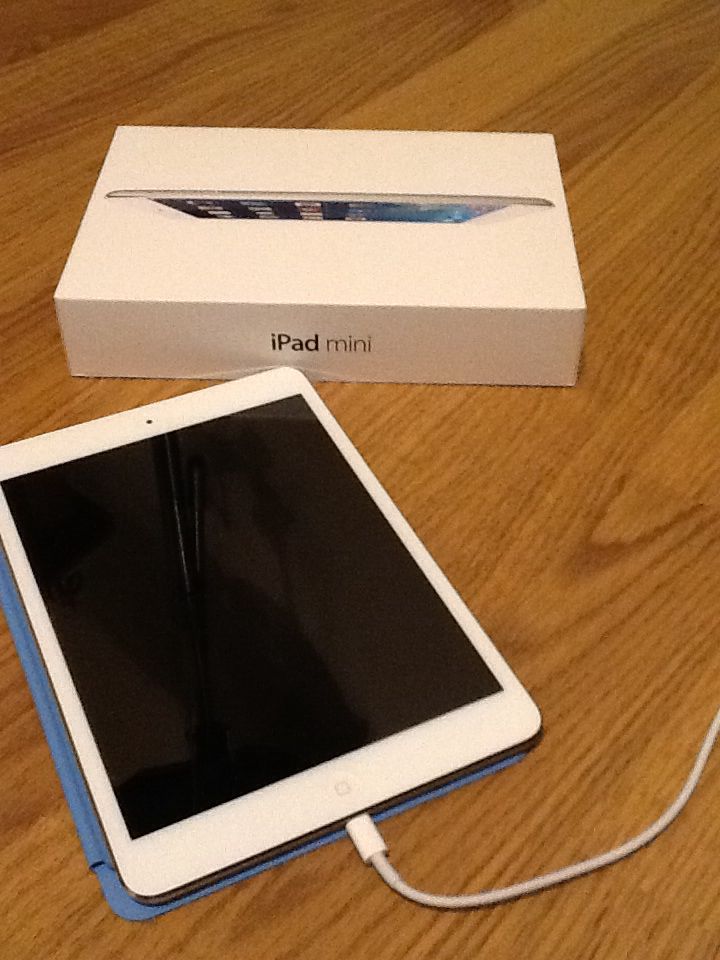 an ipad is sitting on the table next to its box