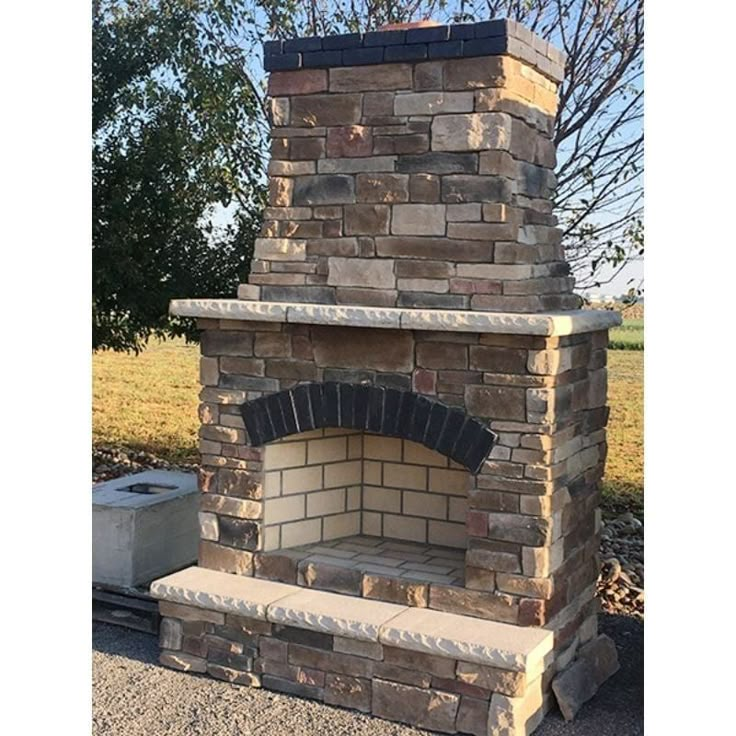 a brick oven sitting in the middle of a field