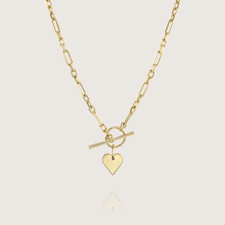 Add a romantic touch to your layered necklaces with this dainty heart necklace made of gold. A perfect heart hanging from a marvelous staple chain. This fine necklace is easy to wear with everything, fits perfectly with other necklaces, and also looks fabulous on it's own. This is a must-have necklace. All features can be customized! Talk to us Our jewelry is carefully handmade in our atelier Our diamonds are conflict free To order by phone click here>> +972(0)722991000 Elegant 14k Gold Filled Heart Necklace, Gold Plated Heart Charm Necklace For Wedding, Wedding Gold Plated Necklace With Heart Charm, Yellow Gold Necklaces With Delicate Chain For Valentine's Day, Elegant Heart Shaped Chain Necklace With Adjustable Chain, Yellow Gold Delicate Chain Necklace For Valentine's Day, Yellow Gold Necklace With Delicate Chain For Valentine's Day, Dainty Gold Plated Heart Necklace, Valentine's Day Yellow Gold Necklace With Delicate Chain