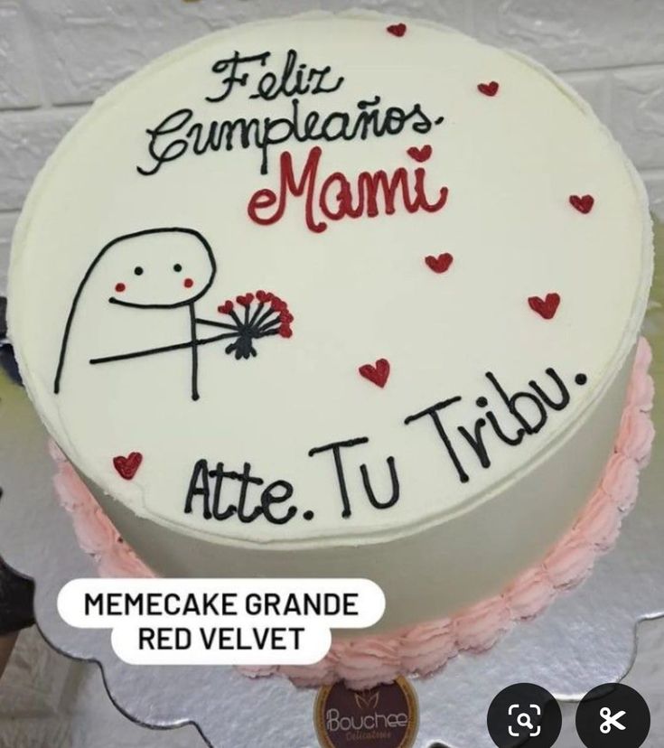 a cake with writing on it sitting on top of a white tablecloth covered table