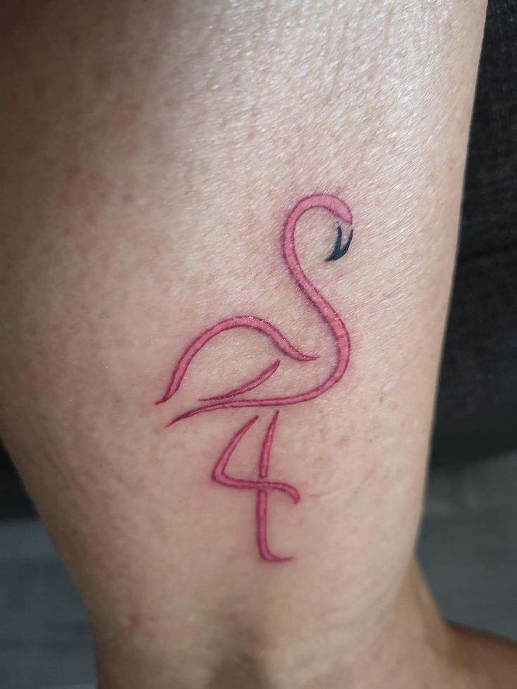 a pink flamingo tattoo on the leg