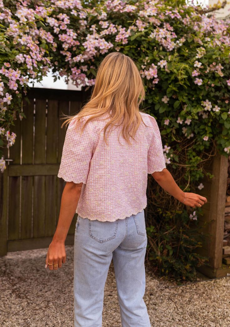 Pink embroidered short sleeve blouse that features a unique and trendy bow to tie on the front. This blouse does not offer lining but is not sheer - the perfect blouse to style up or down all spring and summer long. Our models also wear the Light Blue Maddie Jeans. Sizes: S-M / M-L S-M: Length 20.87 in - Width 18.50 in M-L: Length 21.65 in - Width 19.29 in 50 % cotton, 50 % polyester Washing: handwash Trendy Bows, Parisian Women, Perfect Blouse, Embroidered Shorts, Embroidered Blouse, Short Sleeve Blouse, Spring Summer Fashion, Sleeve Blouse, Summer Fashion