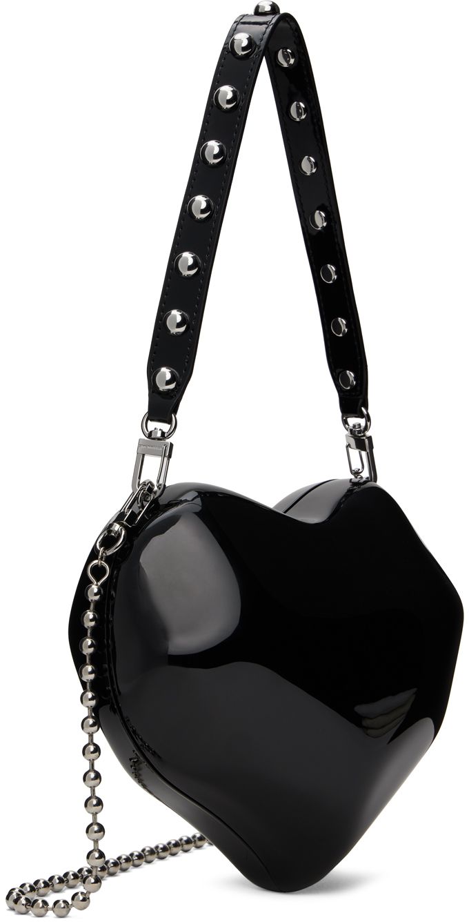 Heart-shaped molded resin bag in black. · Detachable patent faux-leather carry handle · Detachable ball-chain shoulder strap · Hinged magnetic closure · Grained faux-leather lining · Logo-engraved silver-tone hardware · H7 x W9 x D4 Supplier color: Black Heart Shape Bag, Resin Bag, Strap Hinges, Monochrome Fashion, Heart Bag, Silver Engraving, Ball Chain, Magnetic Closure, Heart Shape