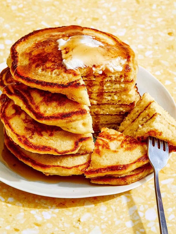 a stack of pancakes with butter on top