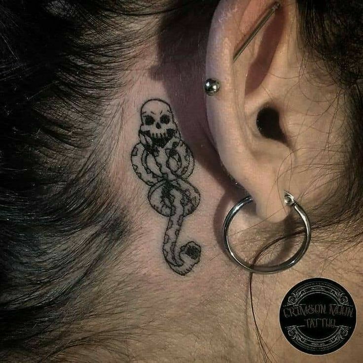 a person with a tattoo on their ear