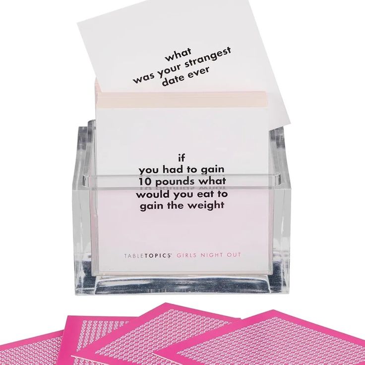 three pink sticky notes in a clear box and one is on top of the post it note holder