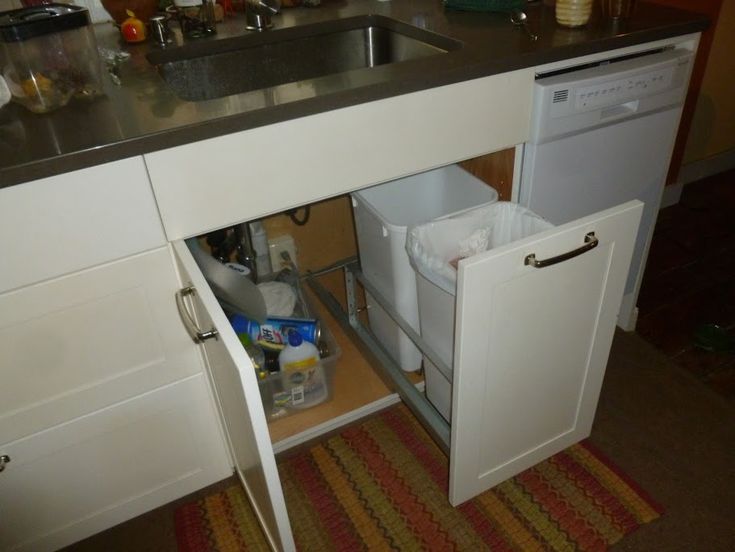 an open cabinet in the middle of a kitchen