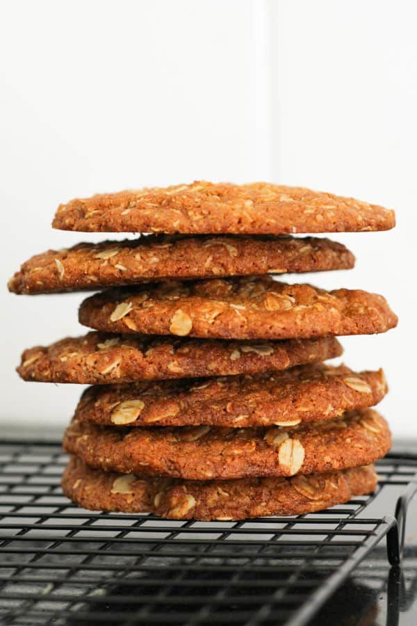 a stack of oatmeal cookies sitting on top of a metal cooling rack