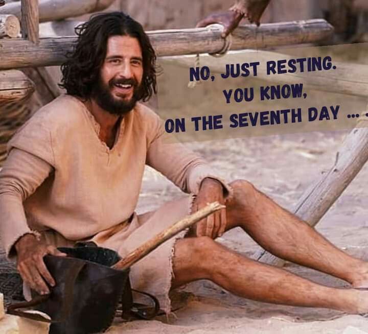 a man sitting on the ground with a stick in his hand and a sign that says, no just resting you know on the seventh day