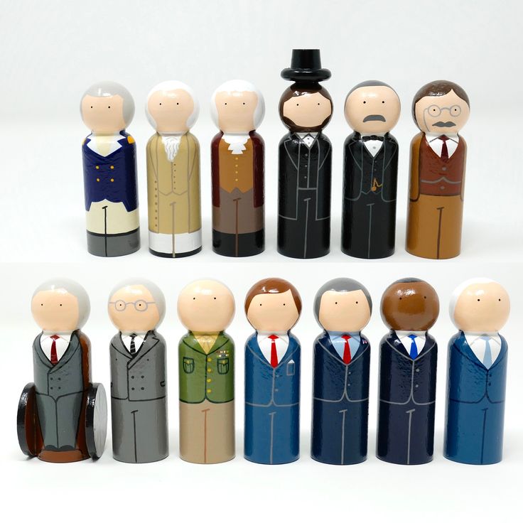 a group of wooden toy figures in suits and ties