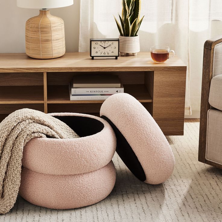 a living room with a pink bean bag chair and coffee table on the floor next to it