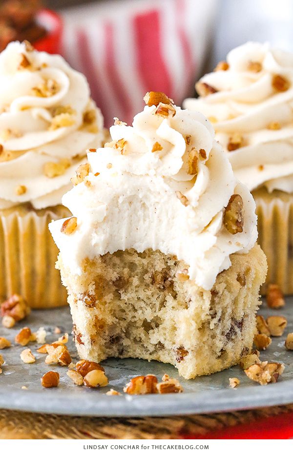 cupcakes with white frosting and walnuts on a plate