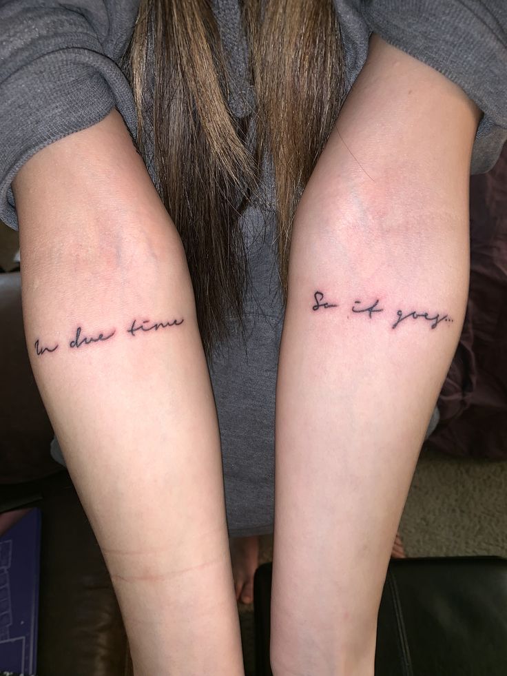 two women with matching tattoos on their arms that say, i do not know what they are