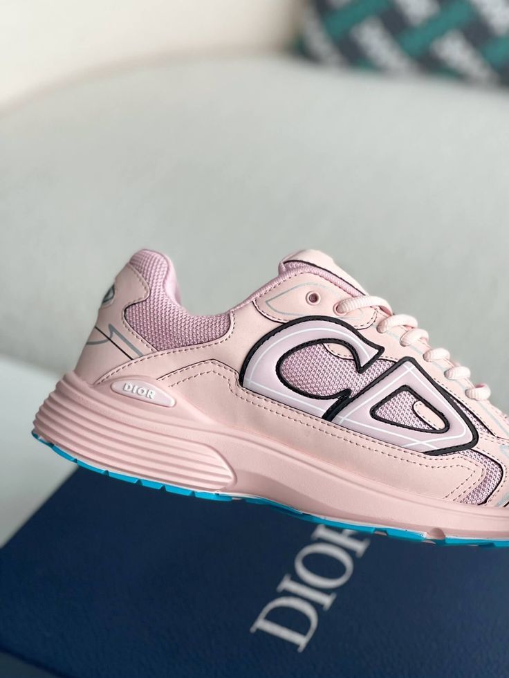 Embrace a playful and sporty aesthetic with these Dior B30-inspired sneakers in a soft pink hue. These eye-catching shoes, crafted with breathable mesh and technical fabric, are perfect for those who want to make a statement. The lightweight construction and sculpted rubber sole ensure all-day comfort and support, while the signature "CD" logo adds a touch of Dior's iconic style. Whether hitting the gym or the streets, these sneakers will elevate your look with a pop of color and undeniable conf Pink Mesh Sneakers For Sports, Sporty Pink Sneakers With Translucent Outsole, Functional Pink Mesh Sneakers, Pink Mesh Sneakers For Training, Pink Sporty Running Shoes For Streetwear, Sporty Pink Running Shoes For Streetwear, Dynamic Pink Sneakers For Jogging, Pink Running Sneakers With Translucent Outsole, Pink Mesh Running Shoes With Rubber Sole