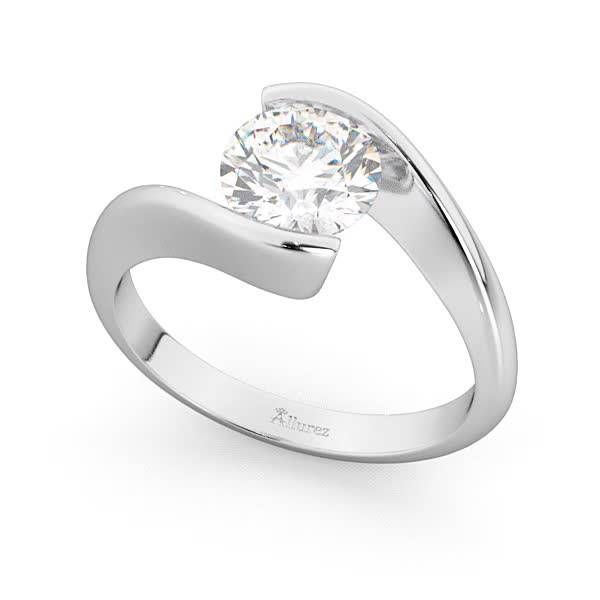 a white gold ring with a single diamond