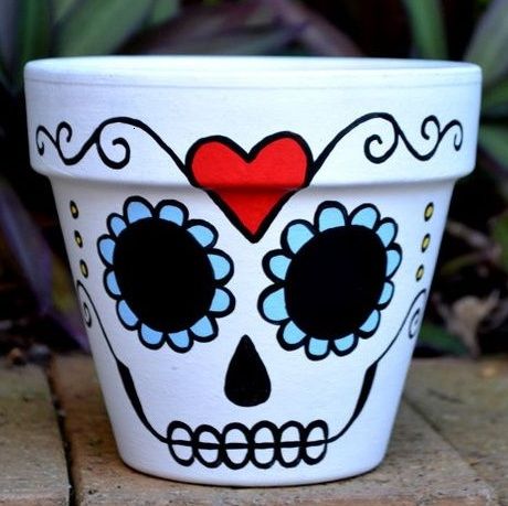 a white flower pot with a red heart painted on it