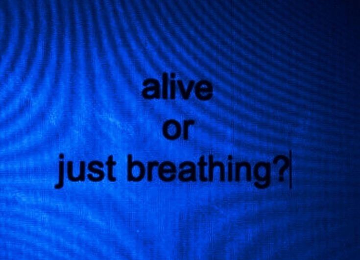 the words alive or just breathing written in black on a blue background