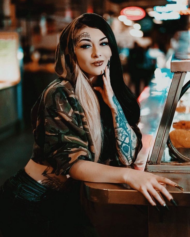 a woman sitting at a counter with her hand on her chin and looking off to the side