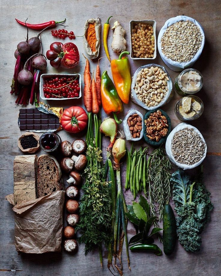 a table topped with lots of different types of vegetables and fruits next to each other