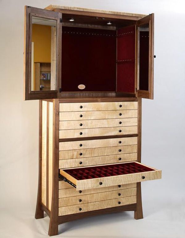 an open wooden cabinet with drawers in it