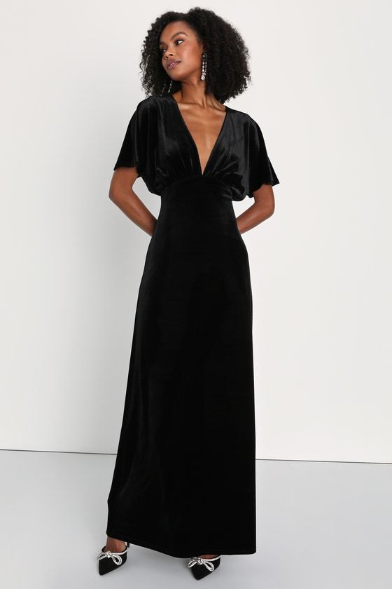 Draw everyone in with your enchanting presence in the Lulus Mystical Charm Black Velvet Flutter Sleeve Maxi Dress! Plush slightly stretchy velvet shapes this chic dress that features a plunging V-neckline, a gathered bodice, and short dolman-style flutter sleeves. Empire waist sits atop a column skirt that falls to a sophisticated maxi hem with a thigh-high slit at the side. Turn around to reveal an alluring keyhole-inspired cutout that secures with a button loop closure. Hidden back zipper/clasp. Fit: This garment fits true to size. Length: Floor length. Size medium measures 60" from shoulder to hem. Bust: Great for any cup size. Waist: Fitted - very fitted at natural waist. Hip: Loosely Fitted. Undergarments: May be worn with petals, or no bra. Fabric: Fabric is very stretchy. Lined. She Black Velvet Formal Dress, Long Black Velvet Dress, Black Bridesmaid Dresses Velvet, Black Long Sleeve Velvet Bridesmaid Dress, Black Flowy Maxi Dress With Flutter Sleeves, Anthropology Black Dress, Short Sleeve Black Velvet Dress, Chic Black Velvet V-neck Dress, Black V-neck Maxi Dress With Flattering Silhouette