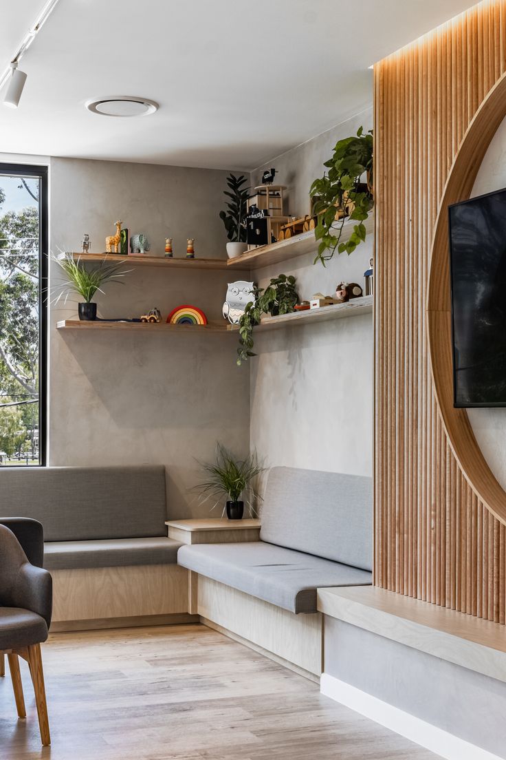 a living room filled with furniture and a flat screen tv sitting on top of a wooden shelf