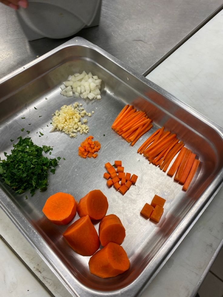 carrots, onions and parsley on a metal tray