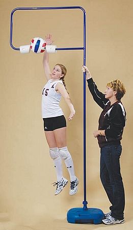 two women are playing volleyball on a pole