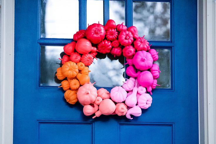 a wreath made out of fake pigs on a blue door