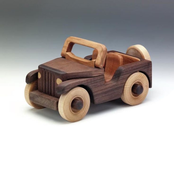 a wooden toy car is shown on a white background