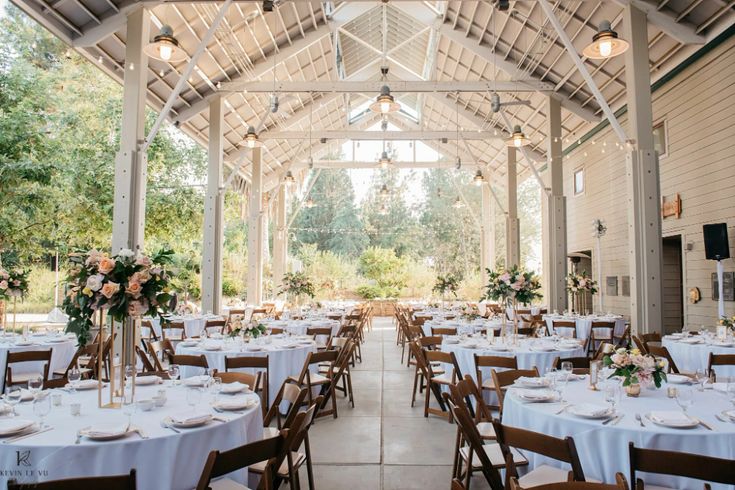 the inside of a building with tables and chairs set up for a formal dinner or function