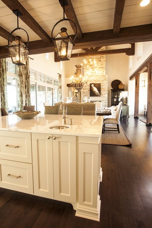 a kitchen with an island in the middle and lots of lights hanging from the ceiling