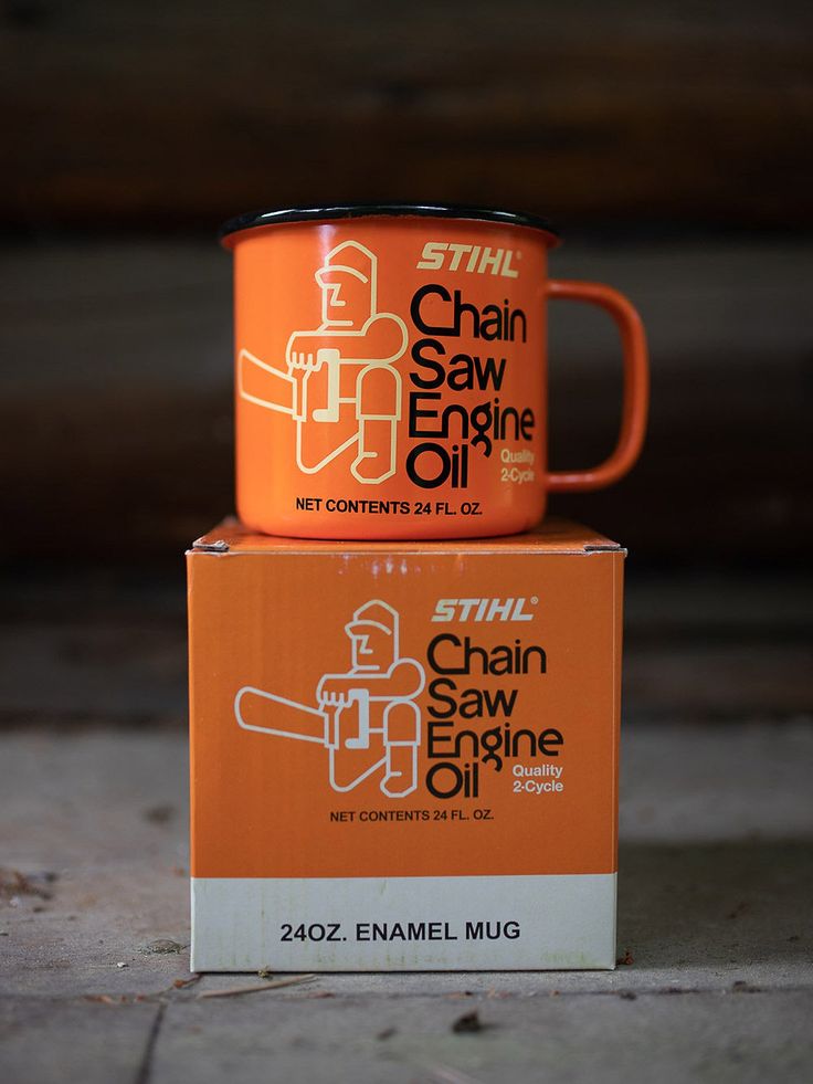 two orange coffee mugs stacked on top of each other in front of a box