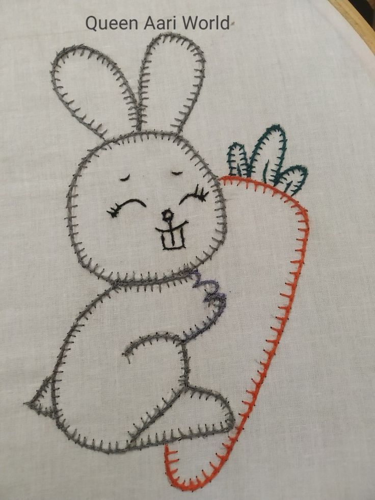 a cross stitch bunny with a carrot on it's back and the words queen ann world