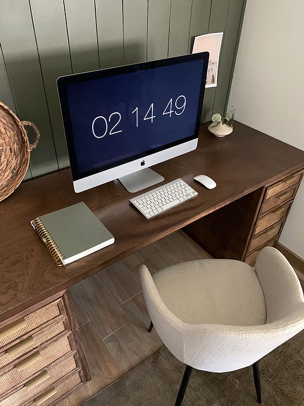 a computer monitor sitting on top of a wooden desk next to a keyboard and mouse