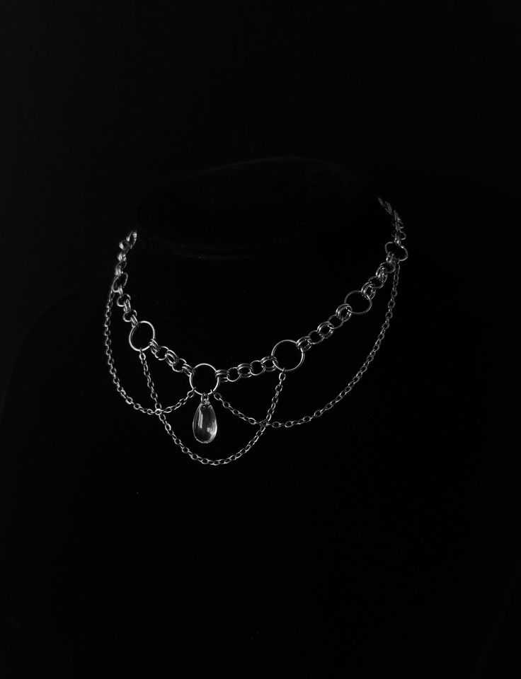 A fine mesh stainless steel chain, a few rings and a crystal drop-shaped bead will be enough to bring originality to your outfit! --------------------------- Chain 0.2 x 0.3 mm in stainless steel Glass drop bead 15 x 8 mm Stainless steel clasps and connectors Minimum length: 30 cm* Maximum length: 39 cm* ⚠ All my jewelry is assembled by hand Jewelry resistant to time provided you take care of it, avoid contact with water. *Can be personalized --------------------------- ✺ Carefully packaged in tissue paper, slipped into an organza pouch and sent in a bubble wrap pouch, perfect as a gift! ✺ Reactive deposit, sending by followed green letter (FRANCE) --------------------------- ✺ Do not hesitate to contact me with any questions! --------------------------- adjustable occult esoteric mysterio Handmade Chain Necklace, Handmade Metal Necklace, Silver Chain Choker, Chainmaille Ring, Chainmail Ring, Chainmaille Tutorial, Gothic Choker Necklace, Metal Choker Necklace, Magic Charms