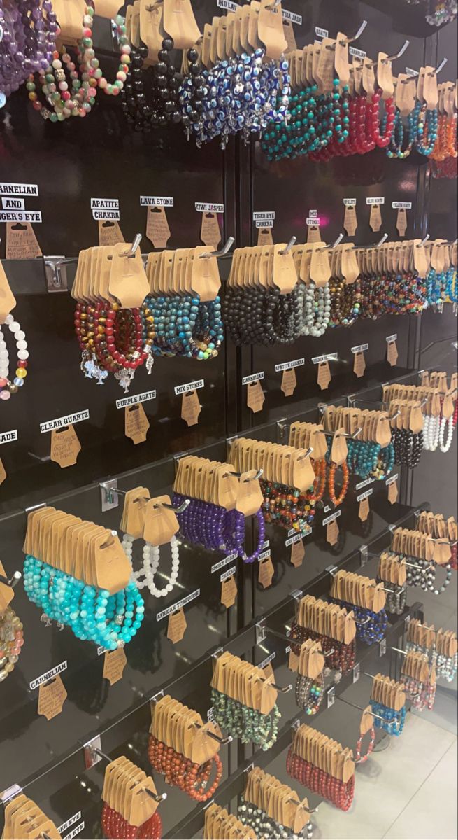 rows of bracelets and necklaces on display in a store