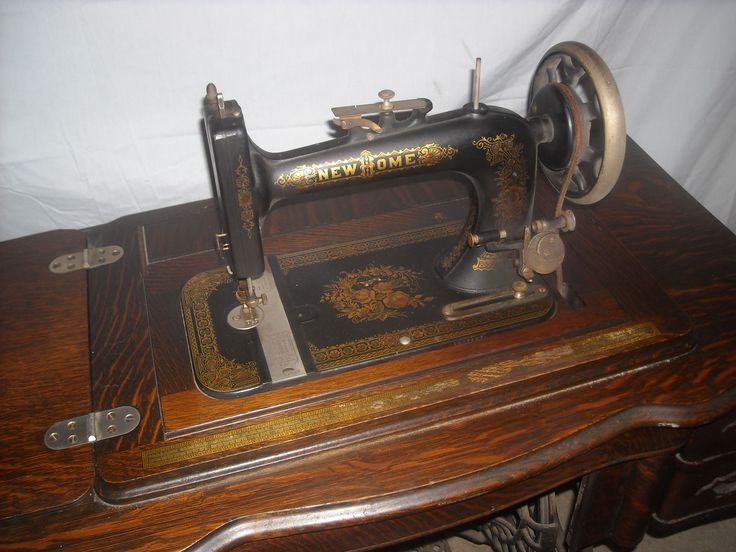 an old sewing machine sitting on top of a wooden table