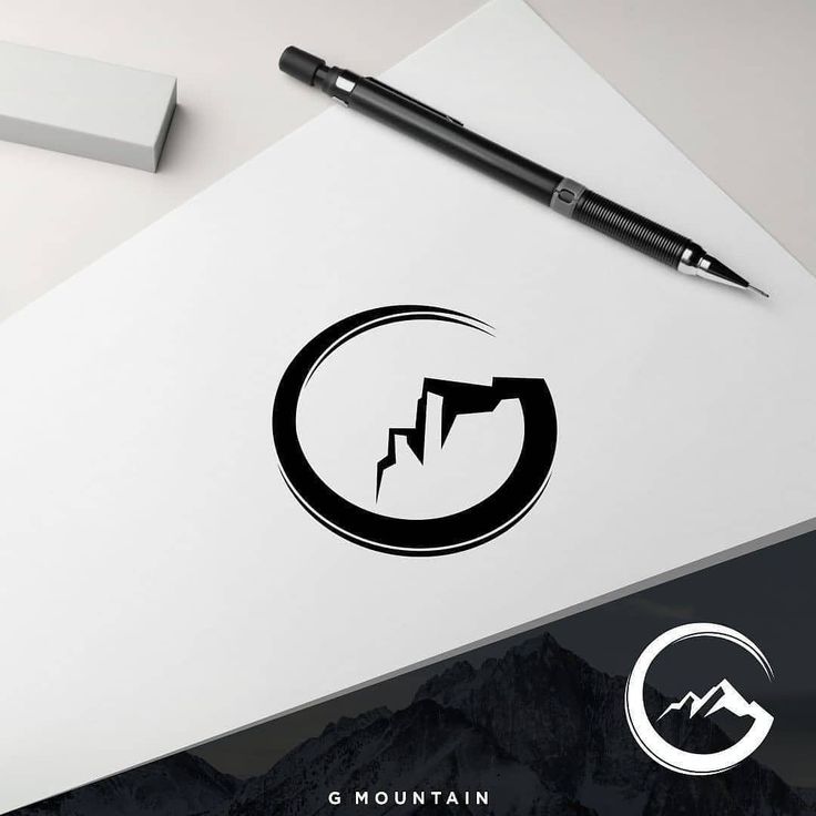 a pen and paper on top of a table with a logo for mountain climbing equipment