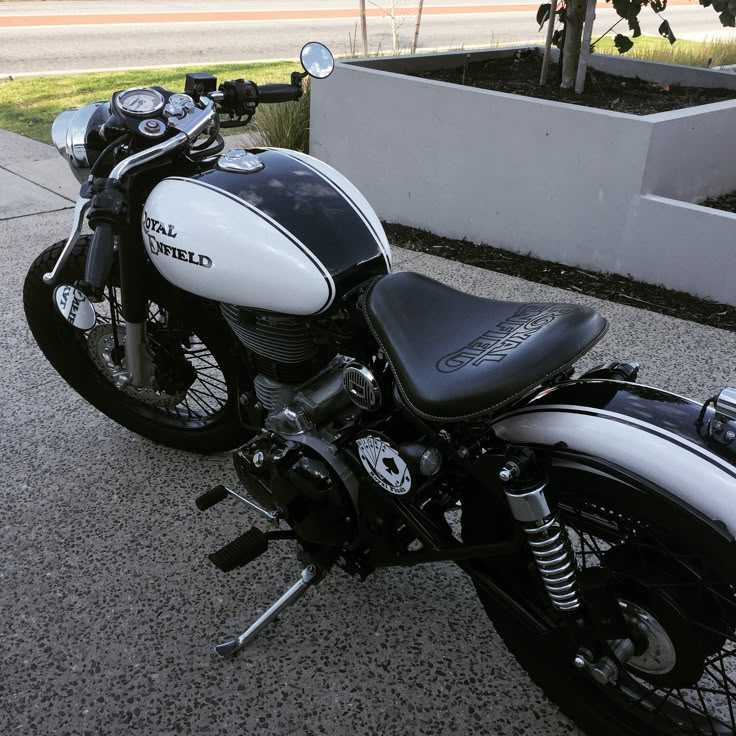 a black and white motorcycle parked on the street