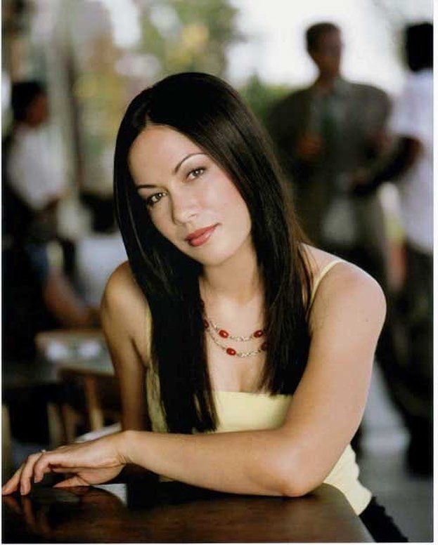 a beautiful young woman sitting at a table