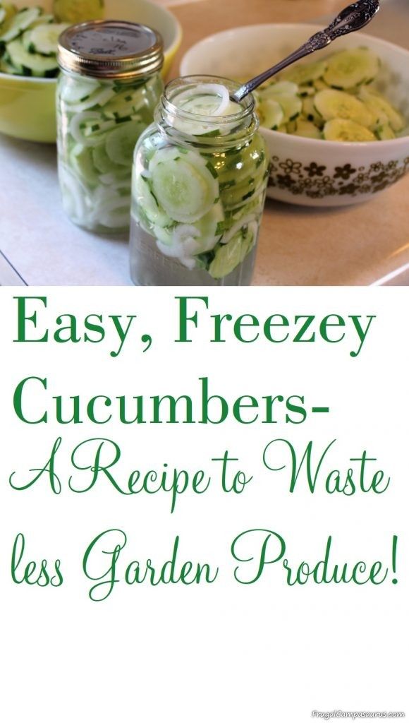 two jars filled with cucumbers sitting on top of a table next to other dishes