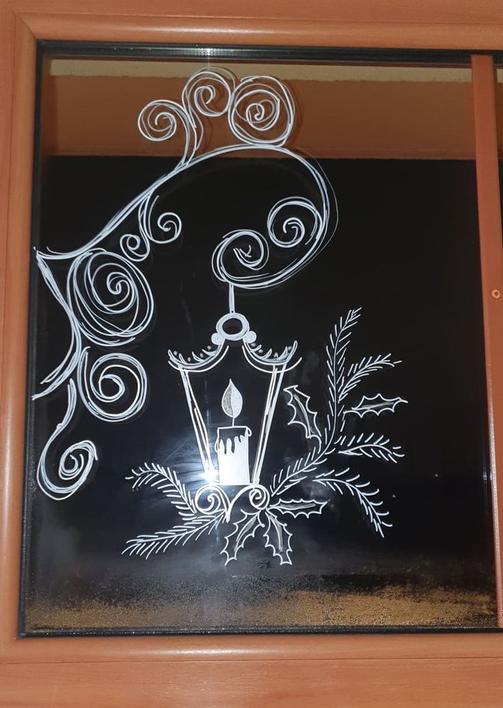 a window with a drawing of a candle on it